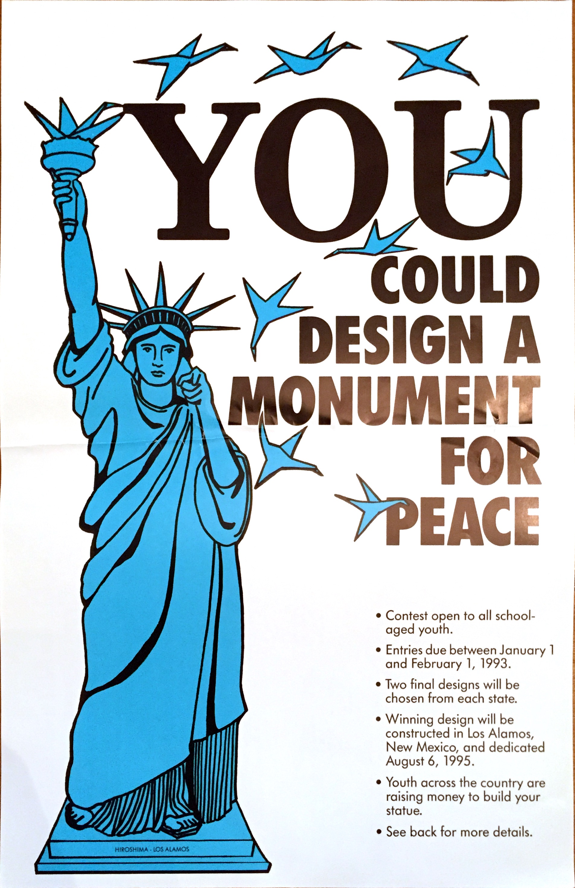 The Statue of Liberty points at viewer, under the large words 'YOU could design a monument for peace.' Folded peace cranes fly from the statue's torch.