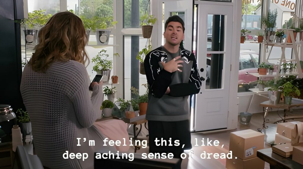 An image of a man standing in a flower shop saying, "I'm feeling this, like, deep aching sense of dread."